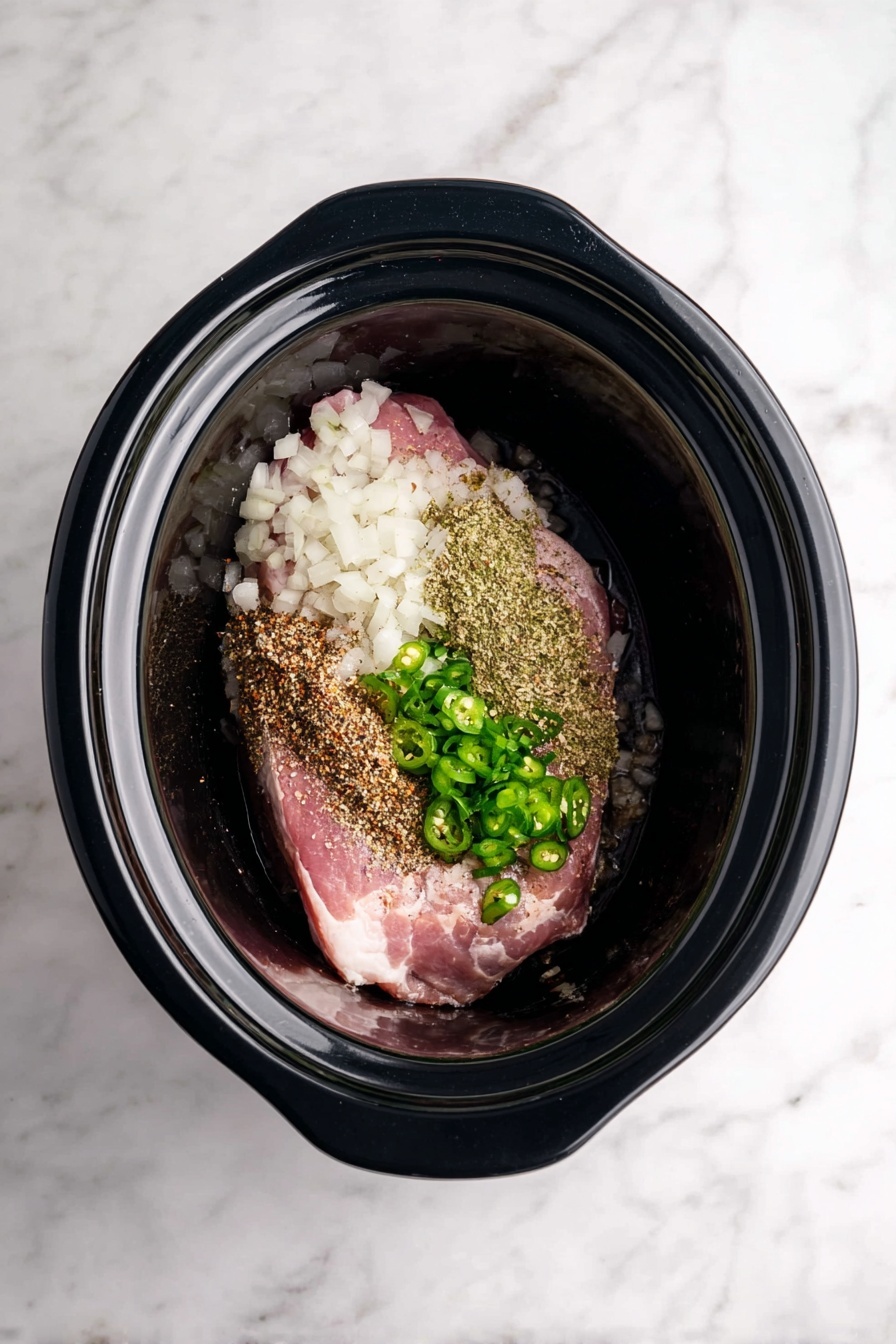 Slow Cooker Carnitas Pork, Carnitas Pork, Easy Pork Tacos, Crockpot Pork, Flavored Pork for Tacos - A rectangular aluminum foil-lined tray holds shredded cooked meat in various brown shades, with some pieces darker and crispy around the edges while others are softer and lighter brown. Shiny tongs rest in the middle, picking up some of the meat. A bright green lime wedge sits on the top edge of the tray. The background shows a white marbled surface with some garlic cloves on the top left and a bright green lime cut in half at the bottom right. Photo taken with an iphone --ar 2:3 --v 7