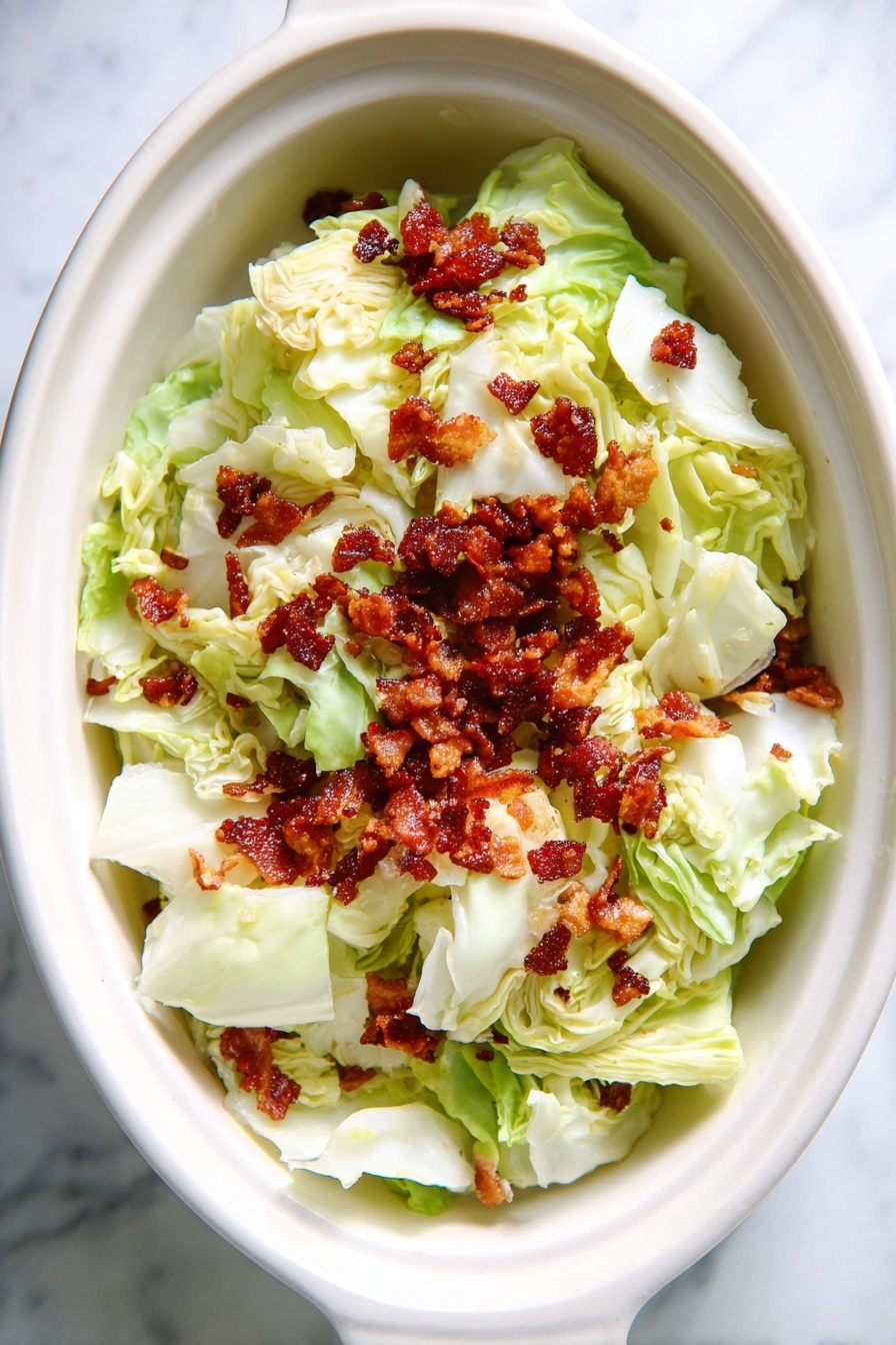 Slow Cooker Cabbage with Bacon, easy cabbage side dish, crockpot cabbage recipe, smoky bacon cabbage, tender slow cooker cabbage - The dish shows a deep white bowl filled with cooked cabbage layers that are soft and light beige with some browned and crispy edges, mixed with small pieces of dark brown cooked bacon scattered throughout. The cabbage is glossy from the cooking juices and oil. A metal fork with a dark wooden handle is placed inside the bowl, resting on the bowl edge. The bowl sits on a white marbled surface with a colorful cloth partially visible in the background. photo taken with an iphone --ar 2:3 --v 7